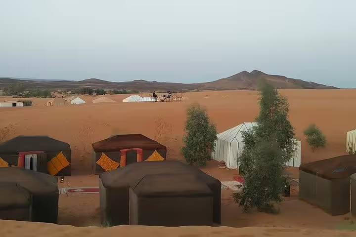 Merzouga Sahara desert camp tents at sunset, Erg Chebbi dunes experience on 9-day Morocco tour from Casablanca