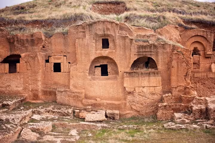 Rock-cut tomb facades carved into sandstone cliffs, a highlight on a 10-day all-inclusive Mesopotamia tour