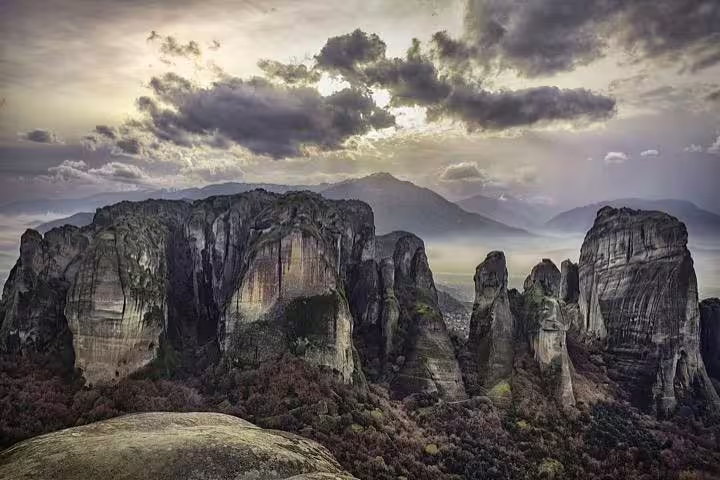 Meteora rock pillars near Kalabaka at sunset, scenic start for private transfer to Athens, Greece