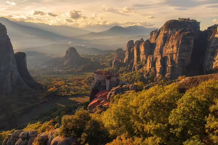 Sunset view of Meteora cliffs and monastery on 2-day private Delphi and Meteora tour from Athens