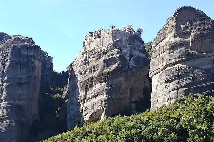 Meteora monastery perched on towering sandstone cliffs, highlight of the Vergina and Olympia multi day tour