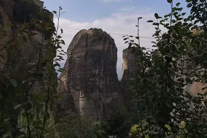 Dramatic Meteora rock pillars framed by greenery, scenic detour on 2-day private Delphi Thermopylae Greece tour