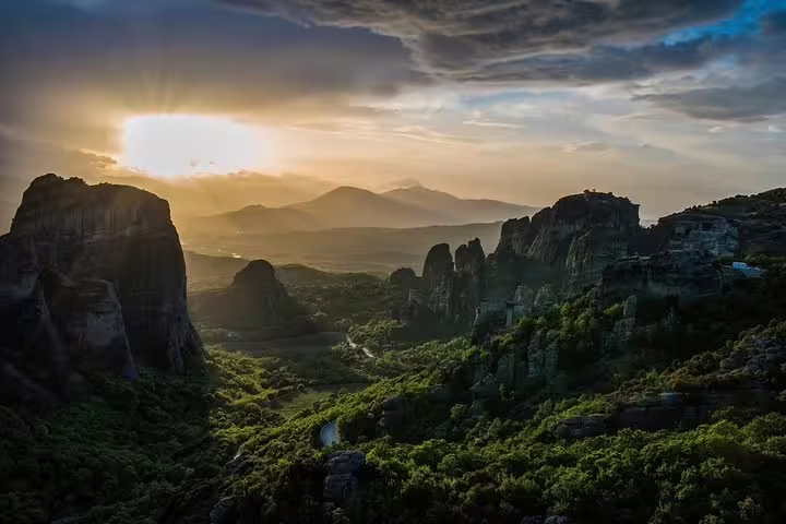 Sunset over Meteora rock pillars and lush valley, highlight of Delphi and Meteora 2-day private tour