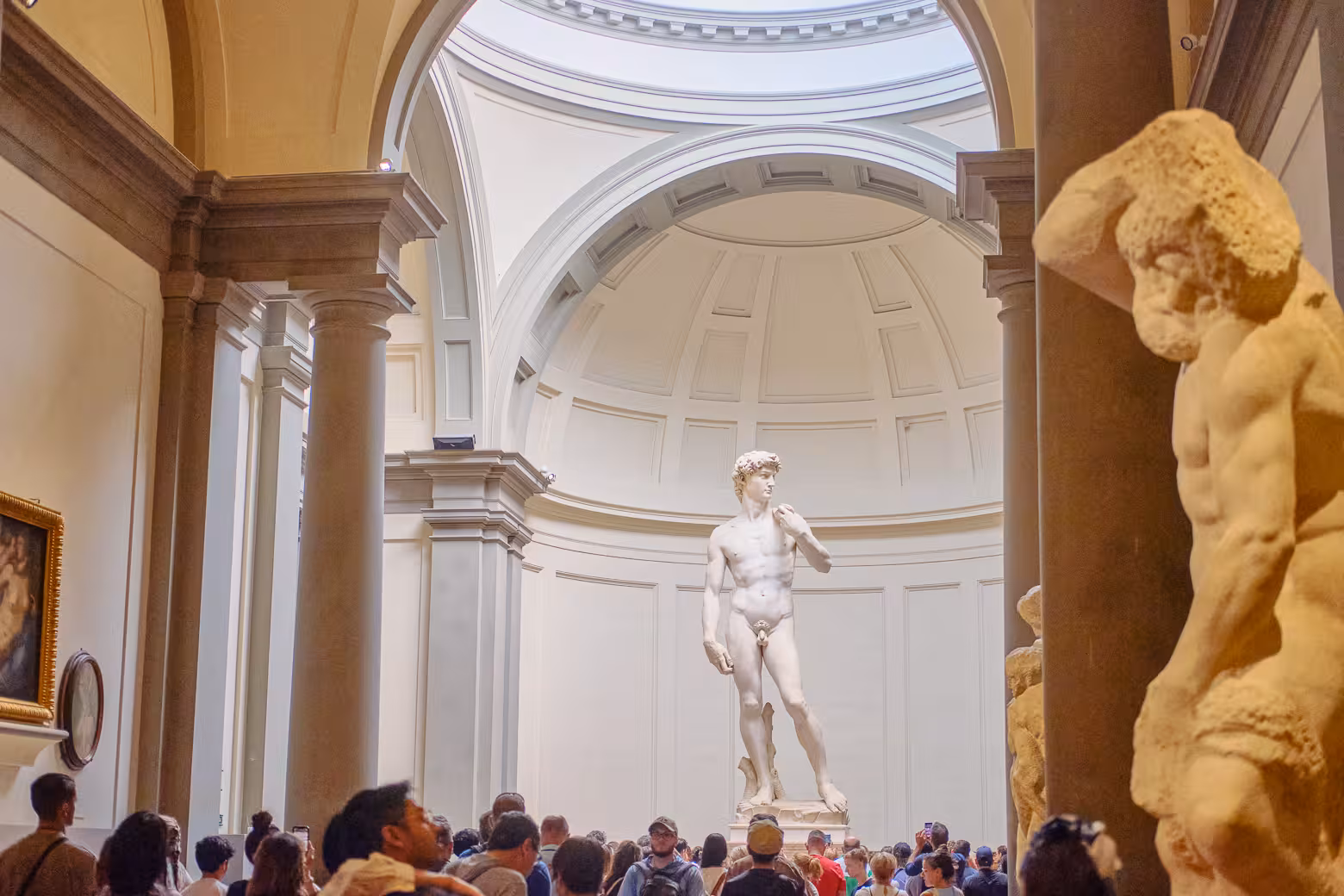 Crowds gather around Michelangelo's David at Accademia Gallery on an exclusive skip-the-line tour from Florence.
