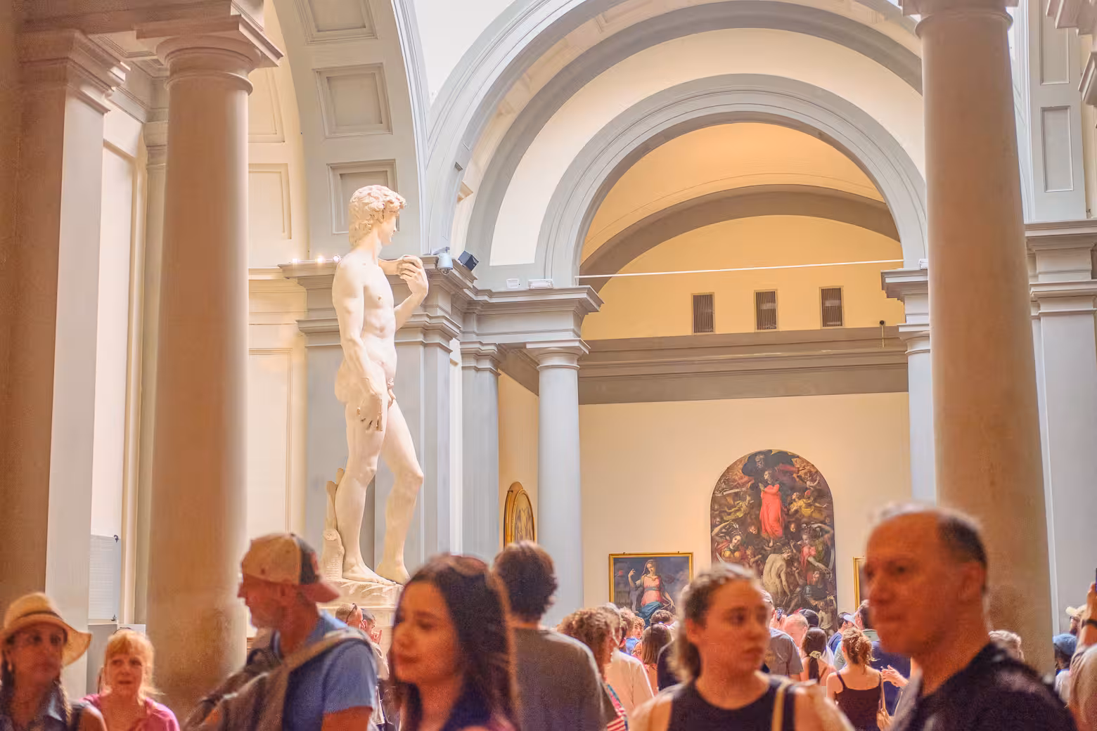Visitors admire Michelangelo's David during a guided tour at Florence's Accademia Gallery.