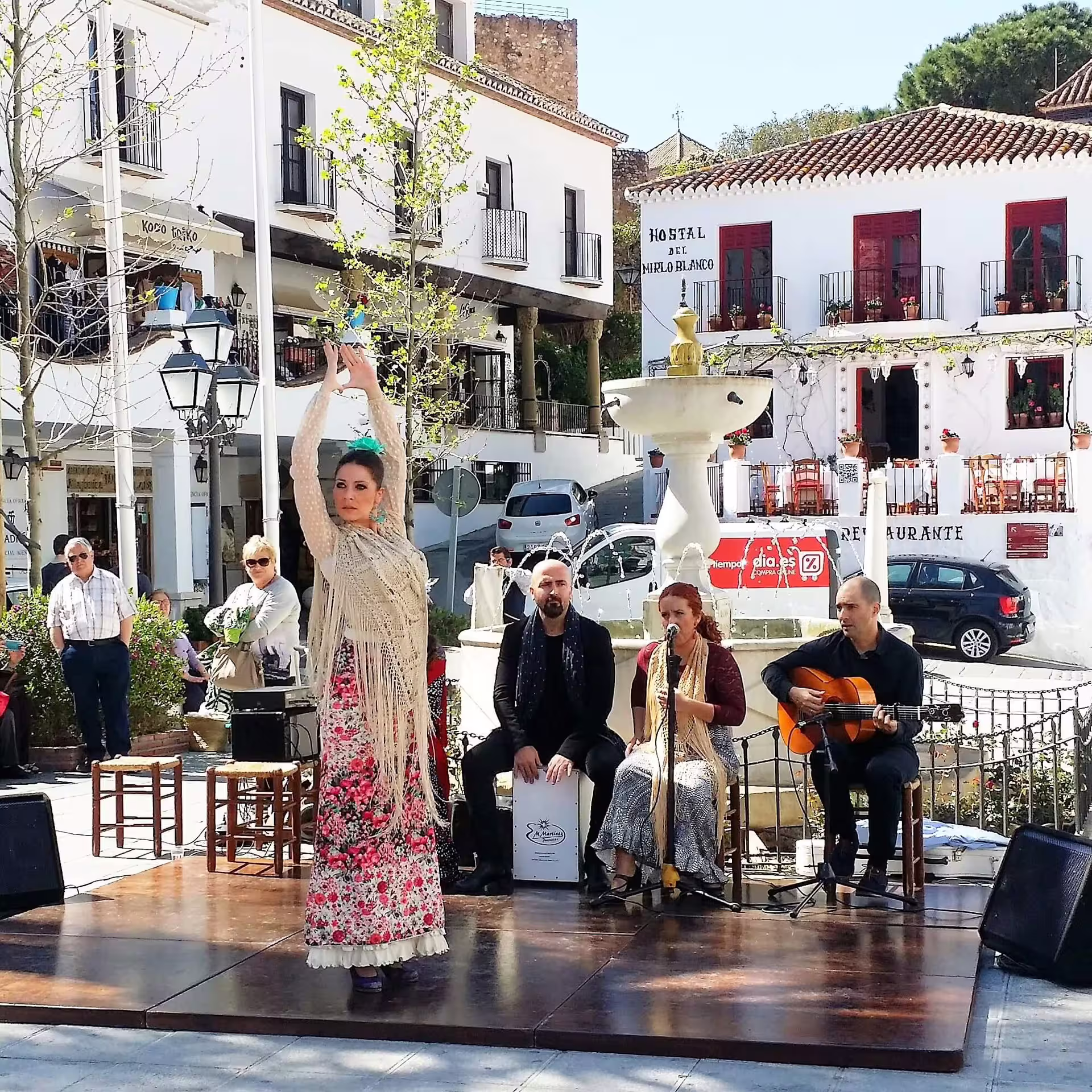 Flamenco dancer and musicians perform in Mijas Pueblo square during guided group walking tour in Andalusia