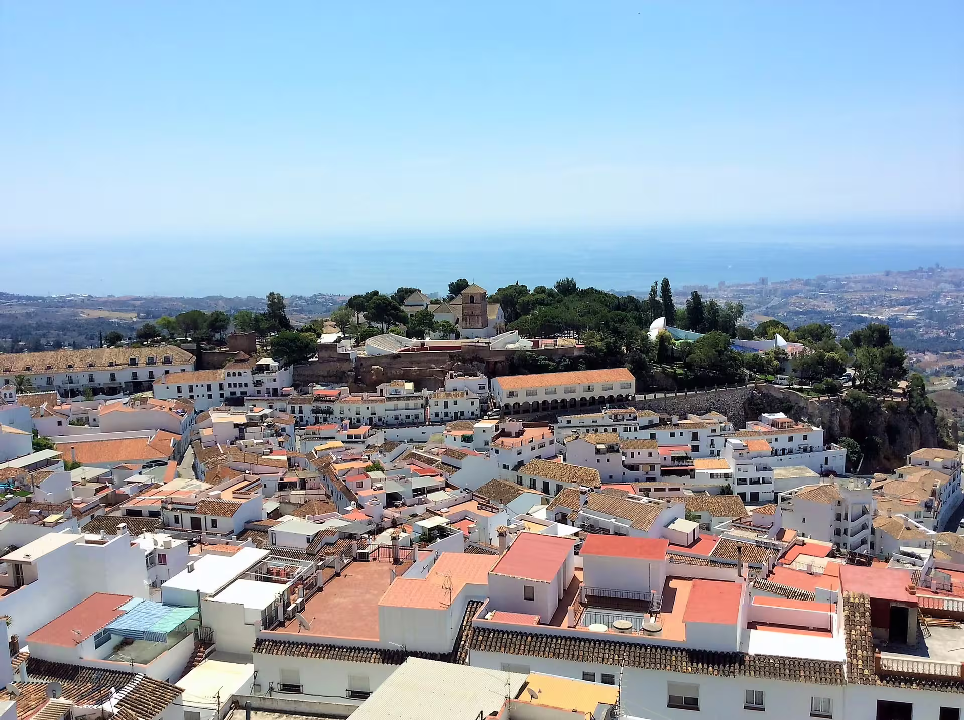 Panoramic view of whitewashed Mijas Pueblo and Mediterranean coast, seen on a guided group walking tour