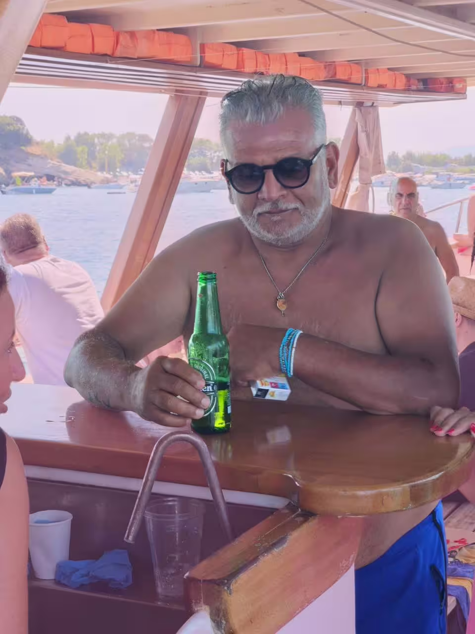 Relaxing onboard bar on Minicrociera Flegrea boat tour, guests enjoying drinks with sea views in Campi Flegrei