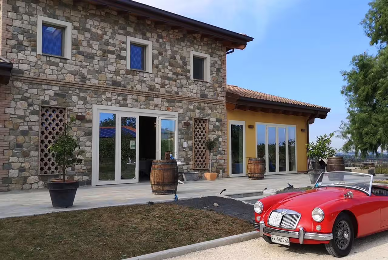 Traditional Modena acetaia stone house with barrels outside, arrival for vinegar cellar visit and tasting tour