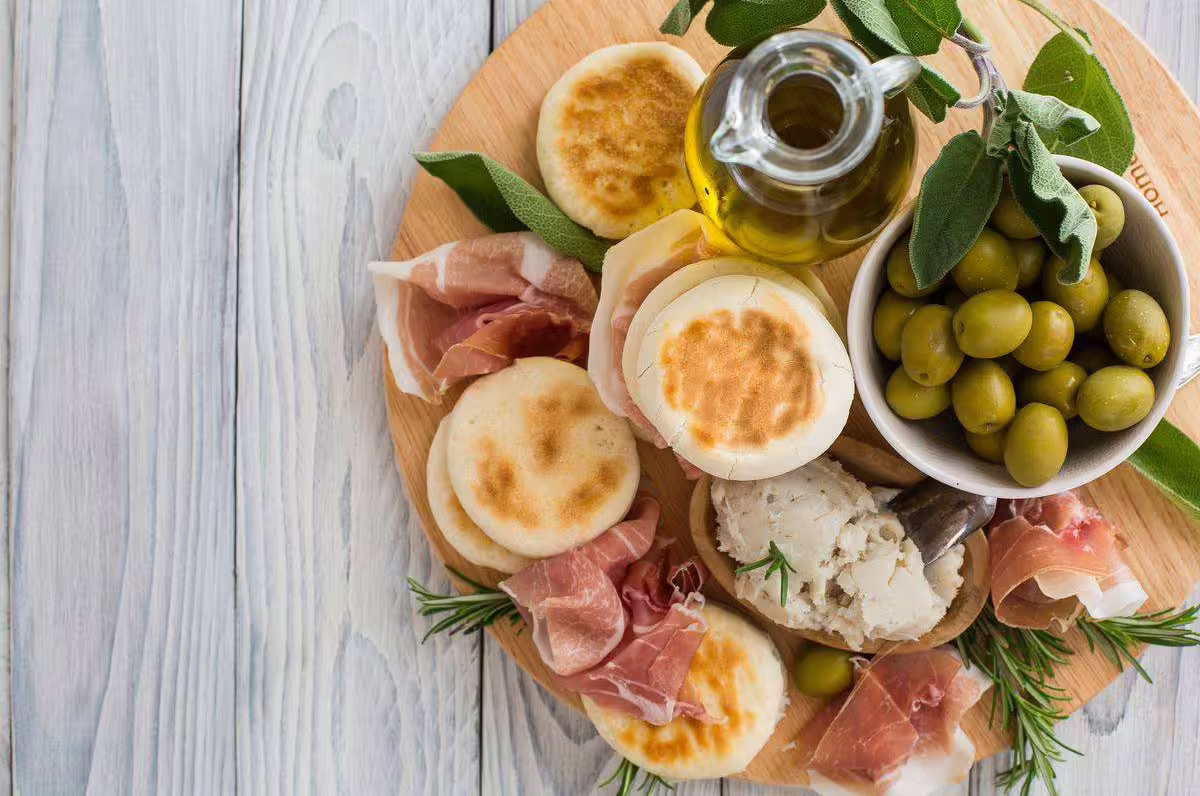 Emilia-Romagna aperitivo board with prosciutto, cheese and olive oil, ideal with Modena balsamic tasting