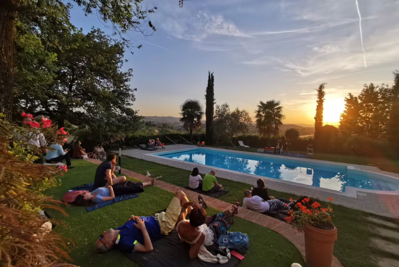 Guests relax by a villa pool at sunset near Modena before visiting an acetaia for balsamic vinegar tasting