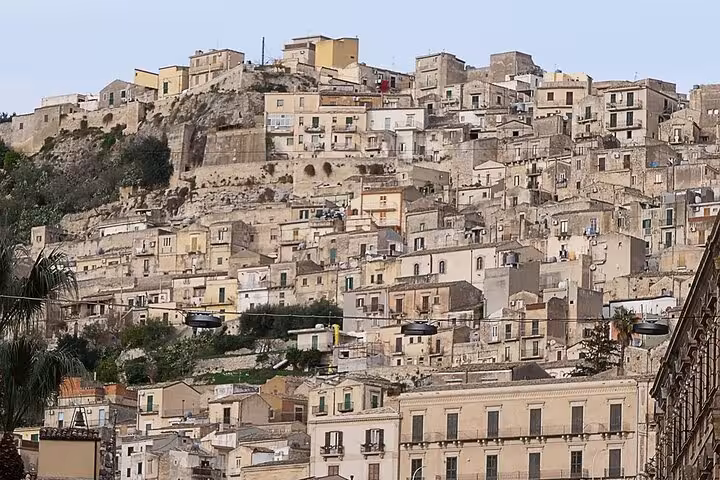 Panoramic view of Modica's rustic hillside architecture on the Baroque cities tour in Sicily.