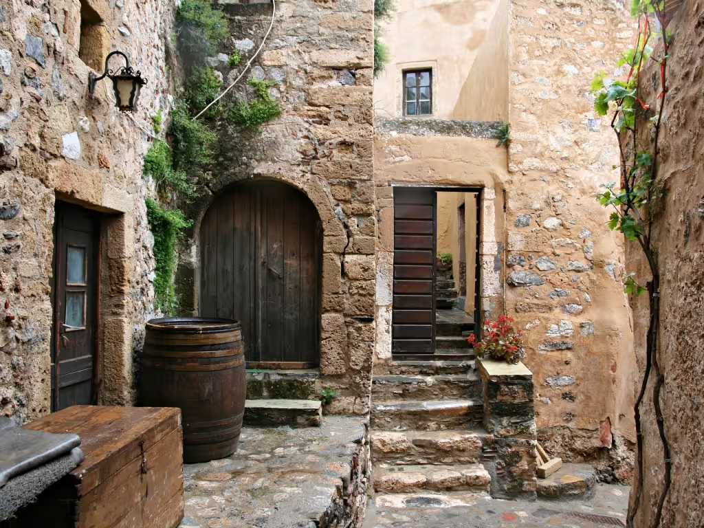 Stone alleyway in Monemvasia old town with arched door, steps and rustic details on a 2-day private tour