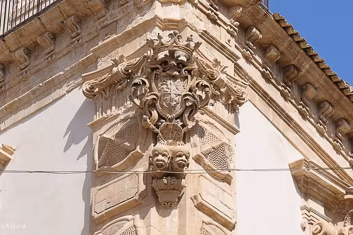 Discover intricate Baroque details on a building facade in Sicily, a highlight of Il Commissario Montalbano tours.