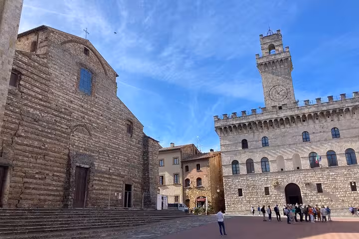 Historical architecture in Montepulciano's main square, a key stop on the Rome to Florence tour.
