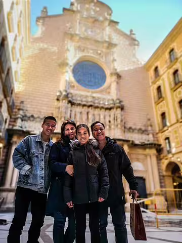 Group enjoying a Montserrat private tour with historic architecture, followed by lunch and wine tasting at a Penedes winery.