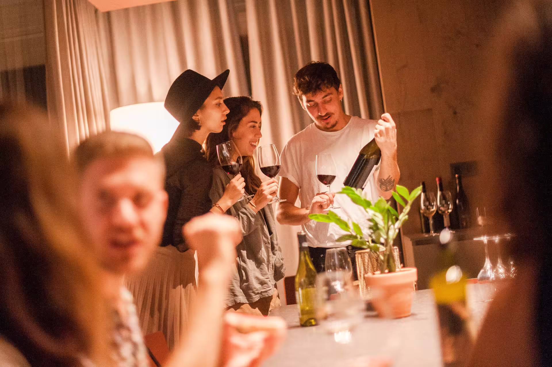 People enjoying wine tasting and tapas at a cozy gathering, highlighting Montserrat culinary tour experience.