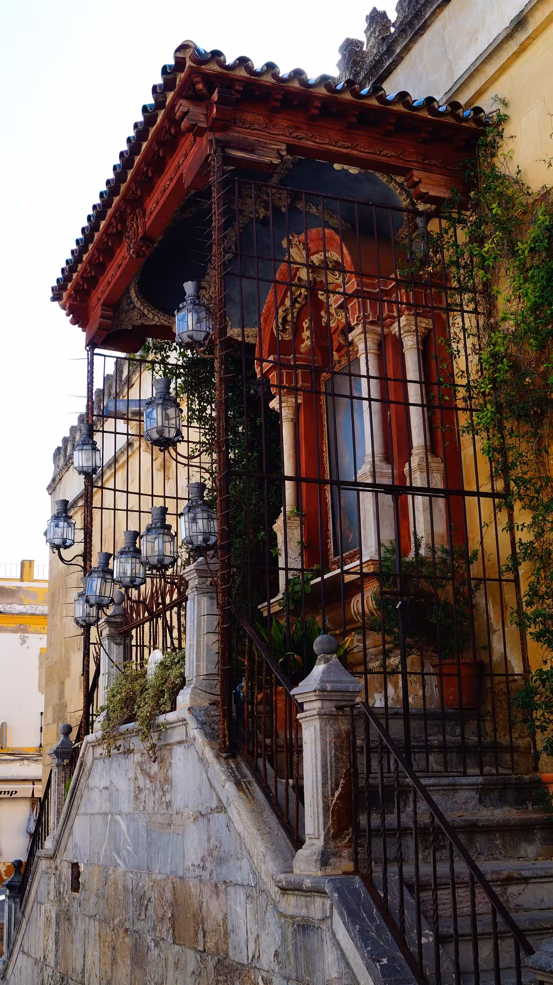 Historic entrance with ornate ironwork and lanterns at the Mosque Cathedral, perfect for cultural tours in Córdoba.