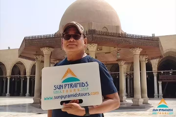 Tour guest at Mosque of Ibn Tulun courtyard, Islamic Cairo day tour in Egypt with local guide