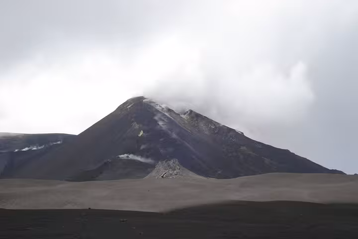 Majestic peak of Mount Etna surrounded by mist, captured during a guided half-day tour at 3000 meters.