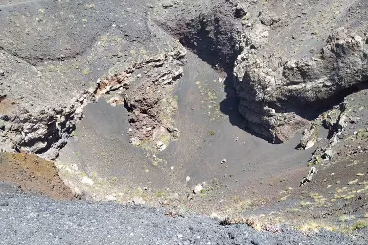 View into a rugged volcanic crater on Mount Etna, showcasing the geological features of this iconic Sicilian volcano.