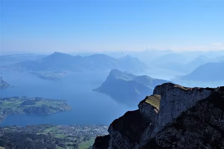 Breathtaking panoramic view of Lake Lucerne and surrounding mountains from Mount Pilatus summit.