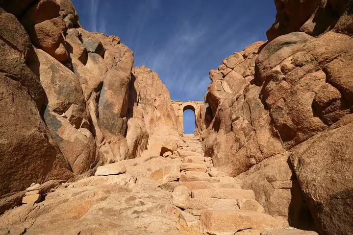Stone steps to Mount Sinai summit arch on sunrise climb from Dahab, Sinai desert hiking trail Egypt