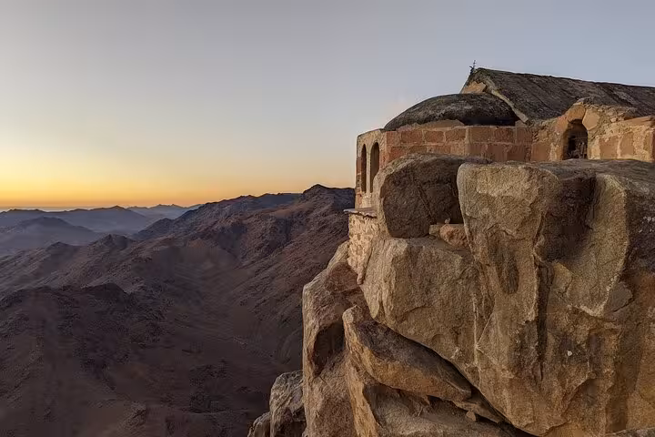 Sunrise view from Mount Sinai summit with chapel ruins, part of St Catherine’s Monastery tour from Sharm