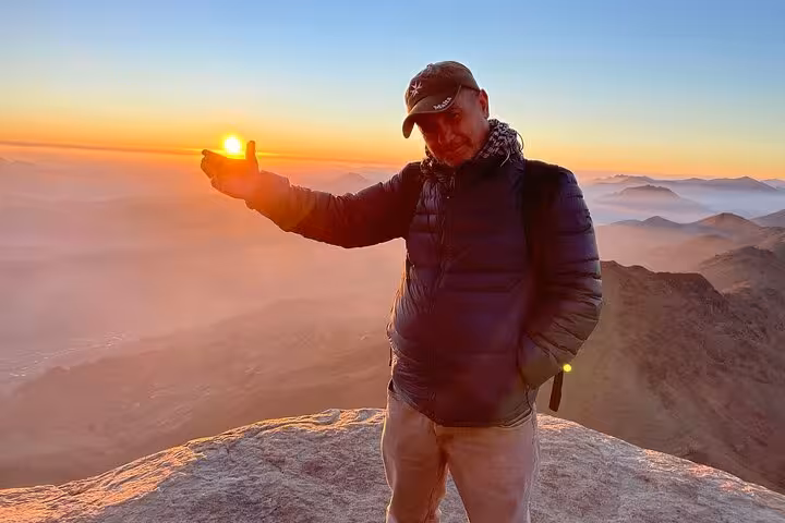Traveler at Mount Sinai summit at sunrise, a highlight of St Catherine’s Monastery tour from Sharm