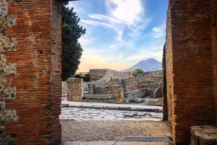 View of Mount Vesuvius framed by ancient Pompeii ruins on a small group guided tour from Positano.
