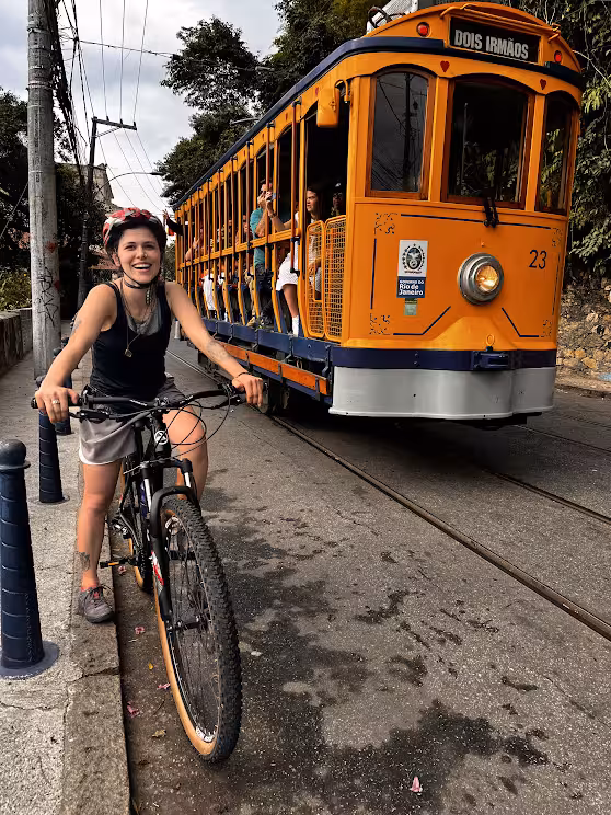 Mountain biker beside Rio’s orange tram on the way to Tijuca Forest rainforest bike tour adventure
