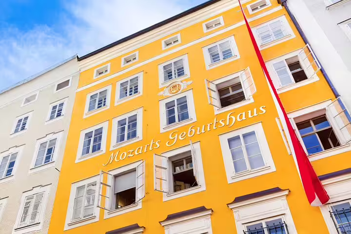 Bright yellow facade of Mozart's Birthplace in Vienna, a highlight of Vienna's Gems and Secrets Private Tour.