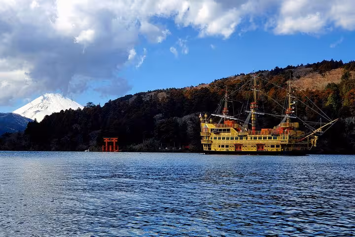 Scenic view of a pirate ship on Lake Ashi with Mt. Fuji and a torii gate, part of the Mt. Fuji & Hakone private tour.