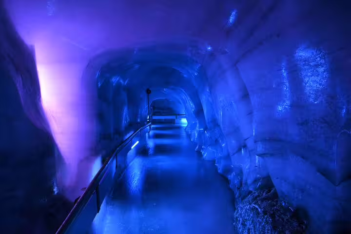 Enchanting blue-lit ice cave walkthrough at Trübsee on Lucerne Mt. Titlis tour, perfect for adventure seekers.