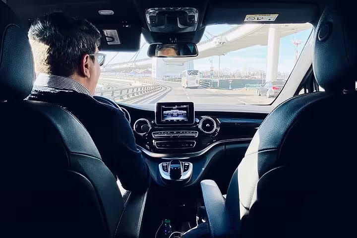 Private taxi driver in modern air-conditioned vehicle starting Muscat classic sightseeing tour along city highway