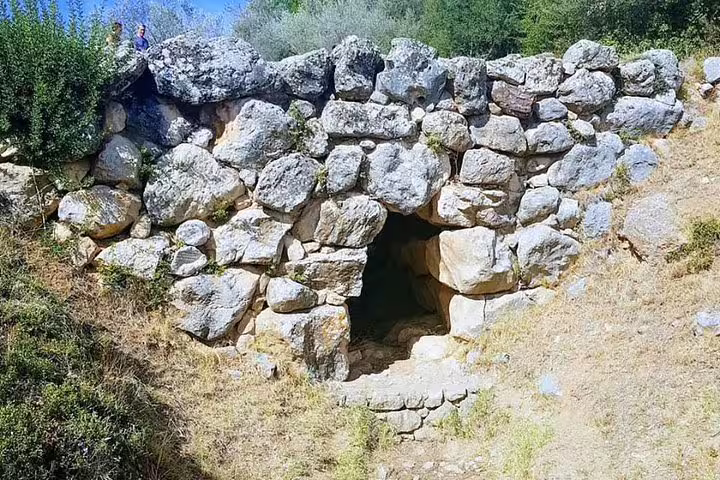 Mycenae beehive tomb entrance with cyclopean stones, visited on Ancient Olympia and Sparta day tour with meal