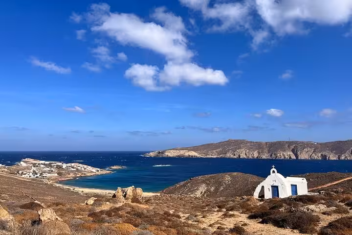 Panoramic Mykonos island coastline and chapel overlooking blue bay, island highlights on private town tour