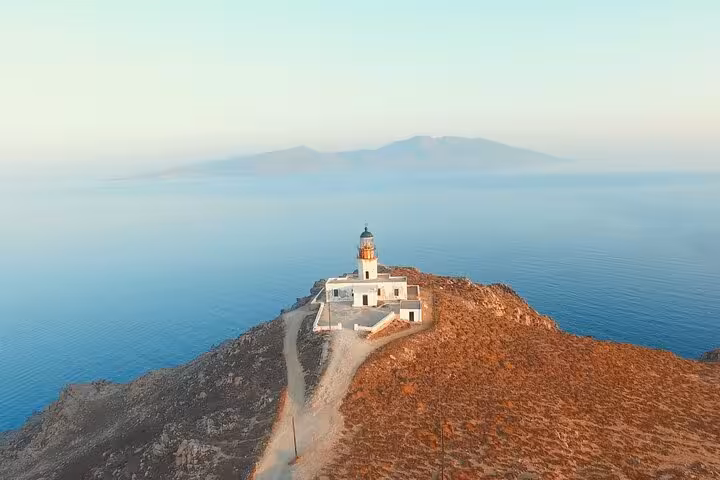 Panoramic Mykonos lighthouse on rocky headland above the Aegean Sea, private island highlights tour