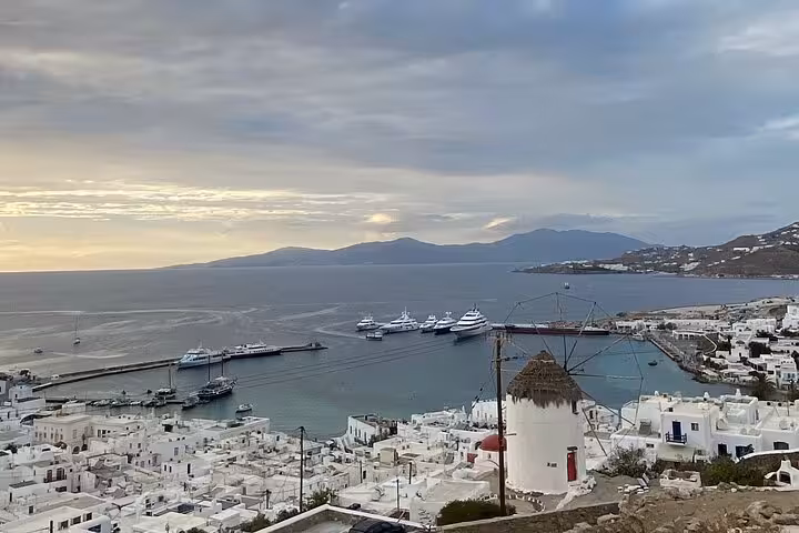 Mykonos Town harbor view with whitewashed houses and windmill, private walking tour island highlights