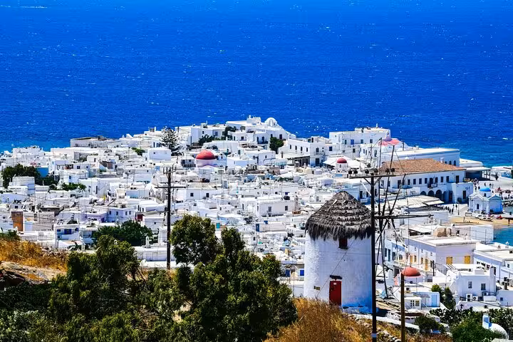 Mykonos Town panorama with iconic windmill and whitewashed houses on a private classic island tour