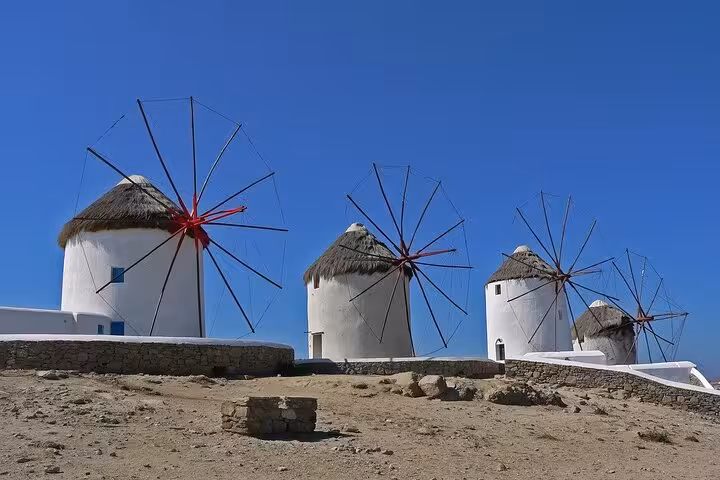 Traditional Mykonos windmills on a sunny hilltop, iconic stop on a private full-day trip from Athens
