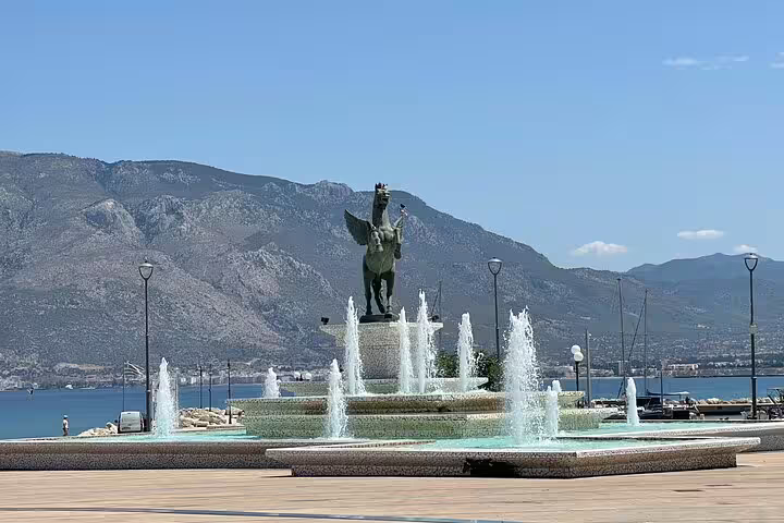 Nafplio waterfront fountain with Pegasus statue, scenic stop on wine tasting experience via Corinth Canal