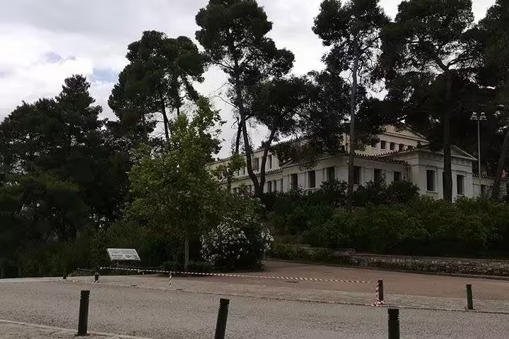 Peaceful pine-shaded square in Nafplion, relaxing break on 2-day private tour to Delphi Thermopylae Mycenae