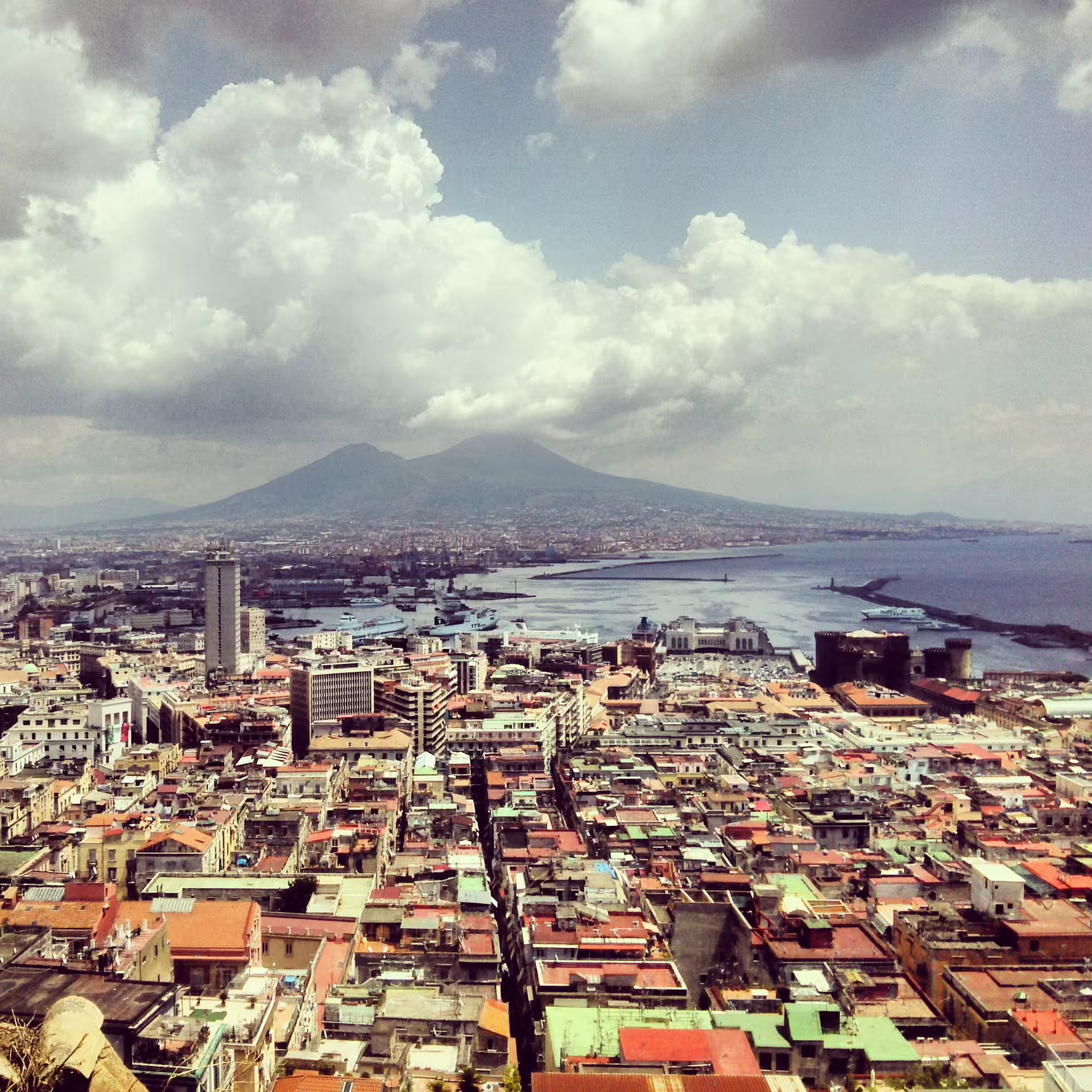 Panoramic view of Naples city and Bay with Mount Vesuvius under clouds on a guided Naples and Amalfi Coast day trip from Rome