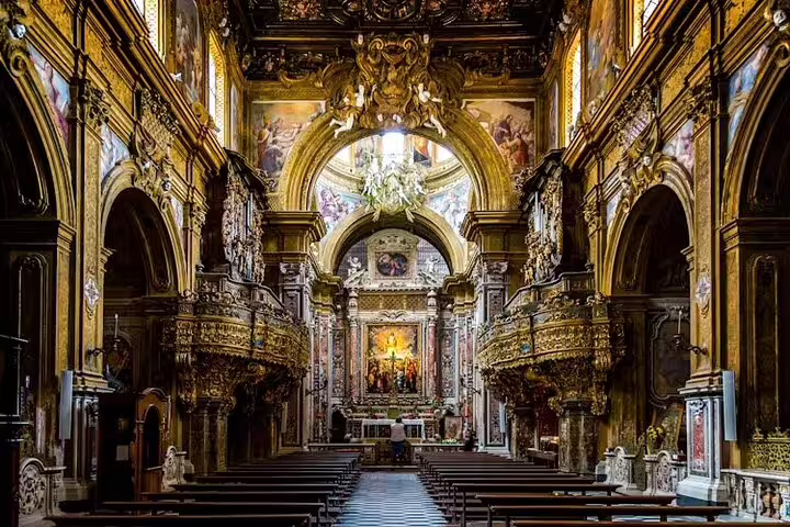 Baroque interior of an ornate Naples church with gilded arches and frescoes visited on a Top Sights & Underground Small Group Tour