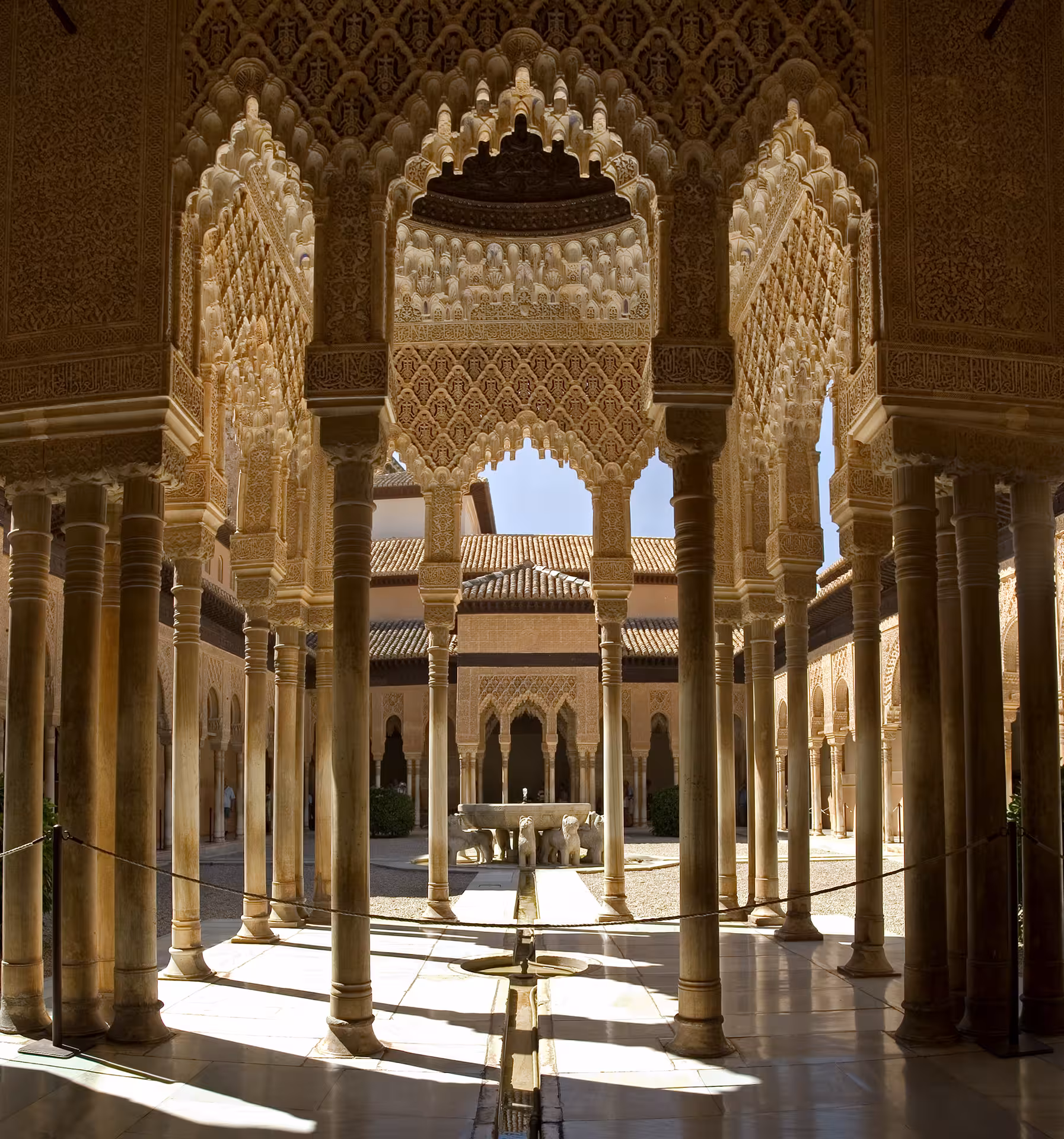 Intricate arches and columns of the Nasrid Palaces' Court of the Lions, showcasing Alhambra's Moorish architecture.