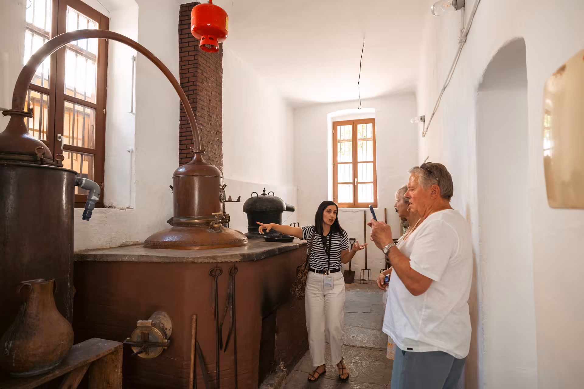 Group visits a traditional Naxos distillery with copper stills during Foodie’s Favourites Village Tour, Greece
