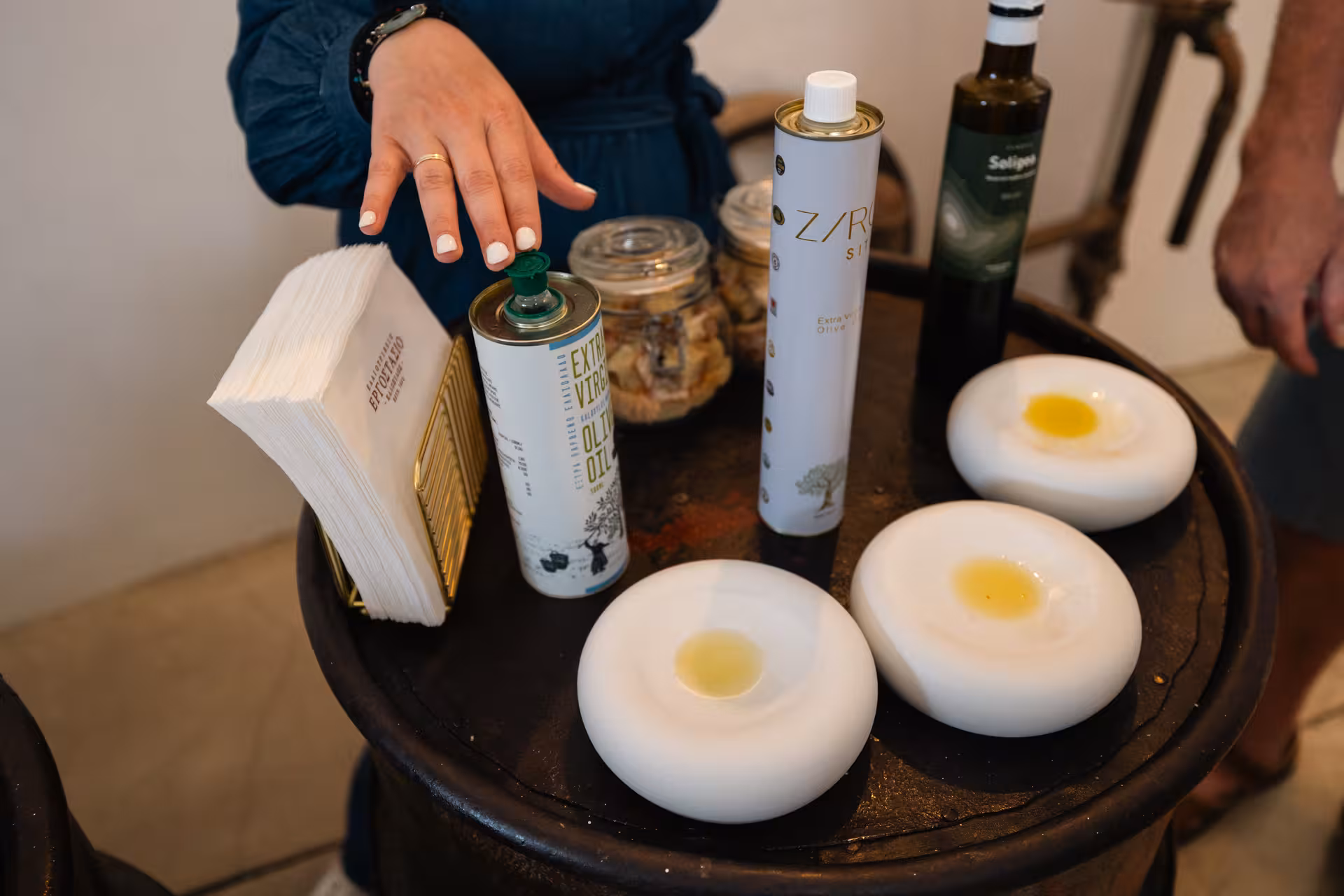 Extra virgin olive oil tasting setup on Naxos foodie village tour, with local bottles and dipping bowls