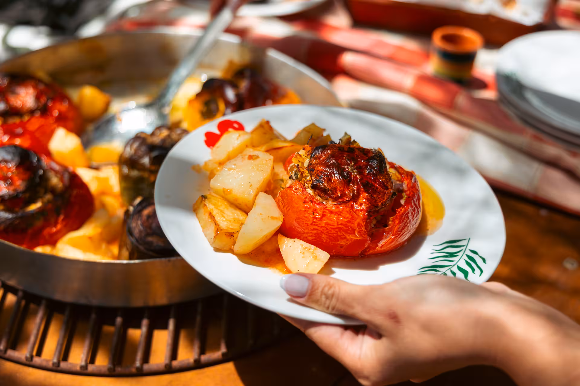 Plate of stuffed tomato and roasted potatoes served after Naxos traditional cooking and cheesemaking class