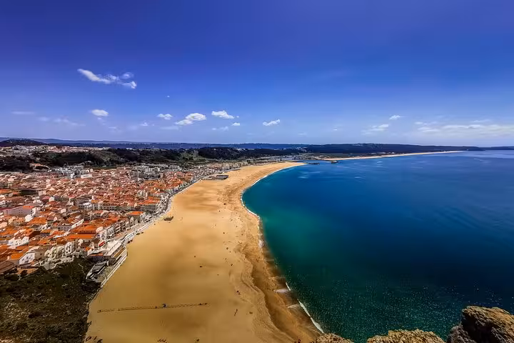 Panoramic Nazaré beach and Atlantic coastline in Portugal, highlight of Three Shrines Pilgrimage tour from Fátima